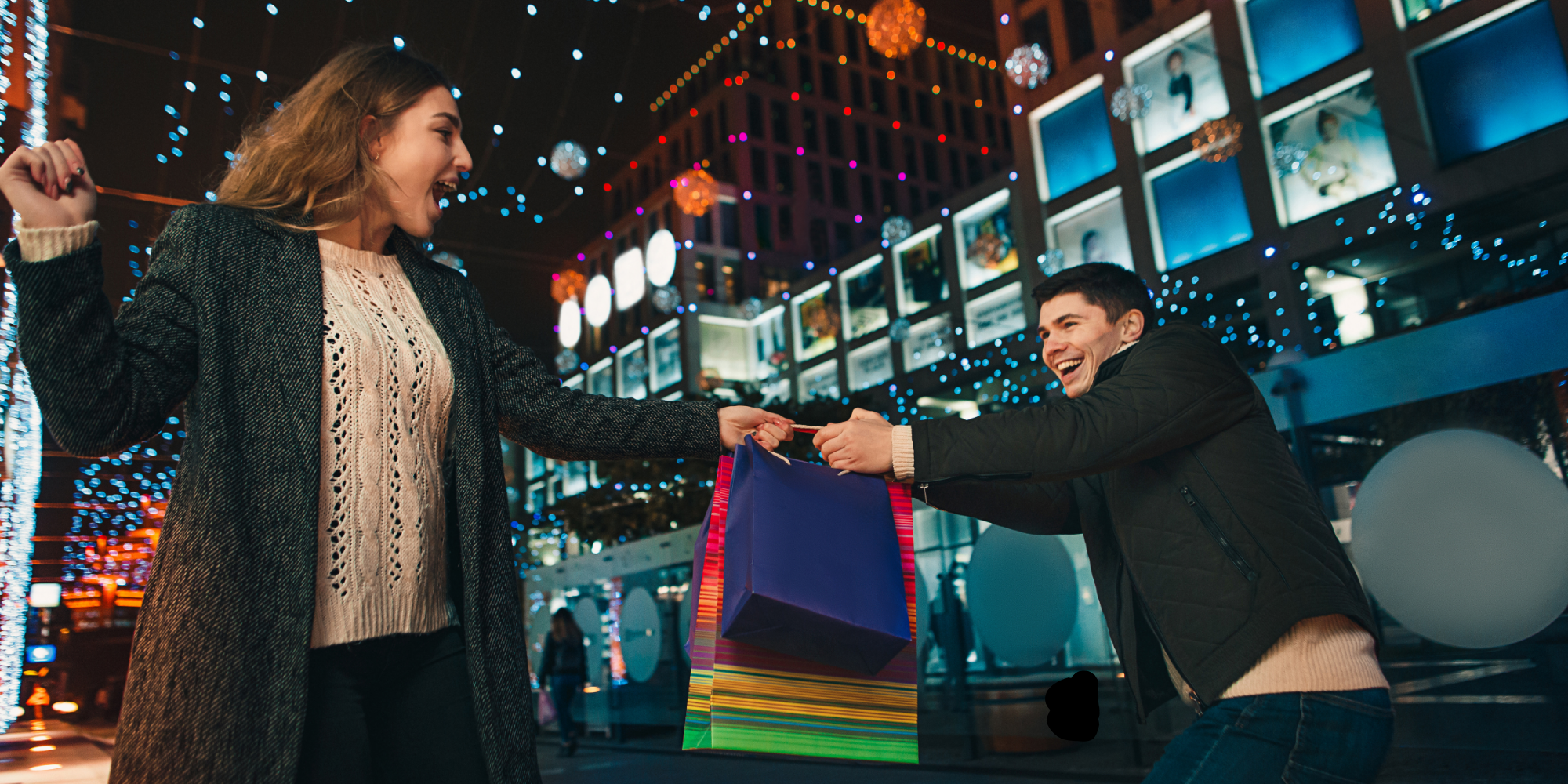 Two people exchanging shopping bags.
